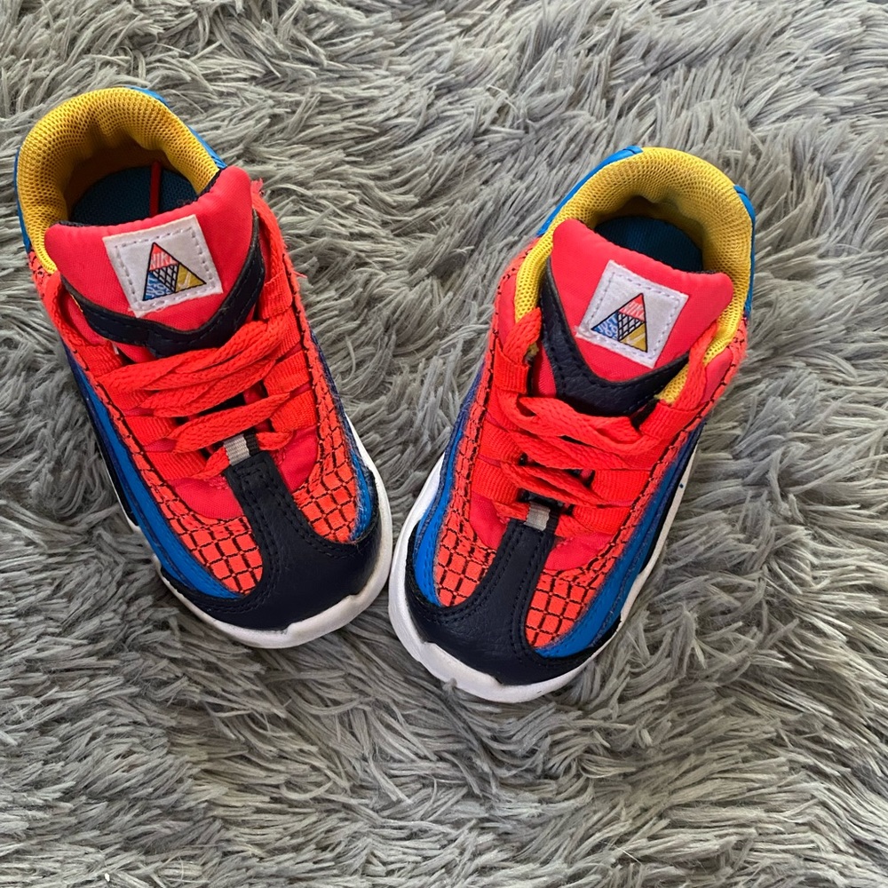 Size 6 in toddler red blue and yellow nikes.